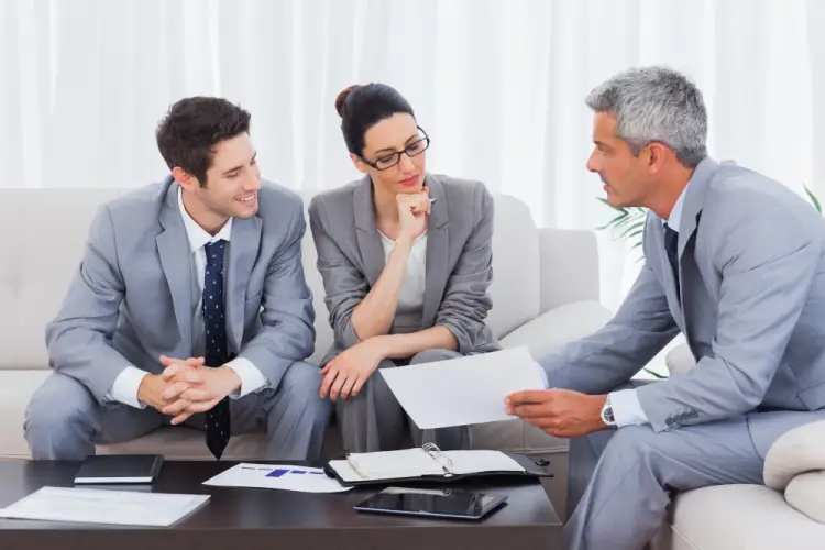 three-colleagues-reviewing-business-report.jpg