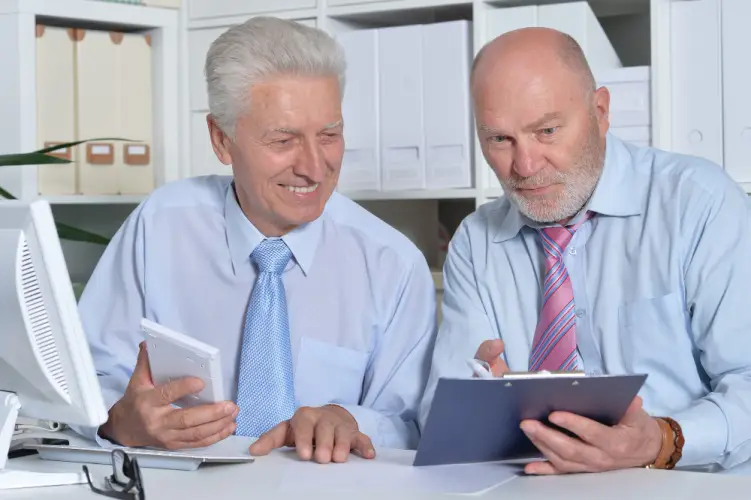 senior-men-reviewing-business-documents.jpg