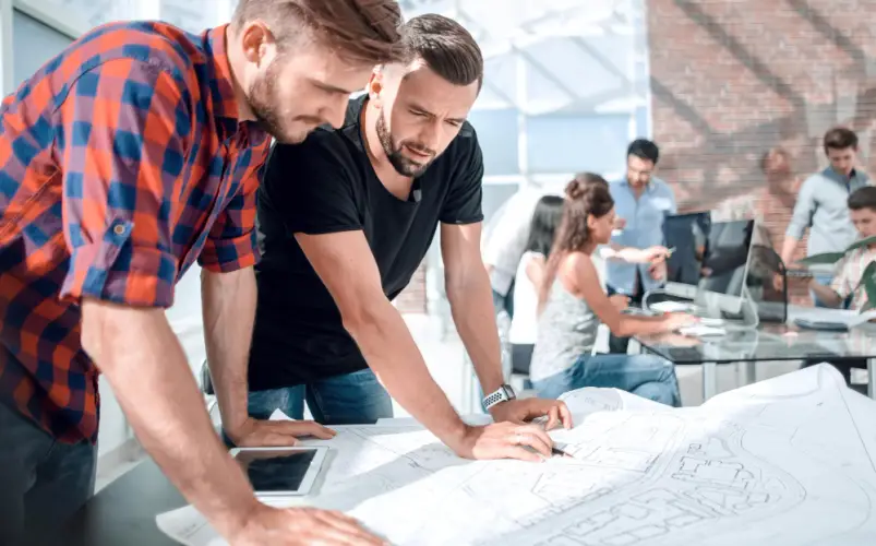 architectural-designers-working-with-building-model.jpg
