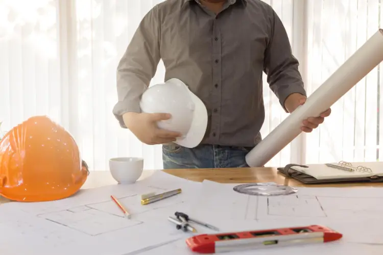 engineering-consulting-hard-hat-blueprints-desk.jpg