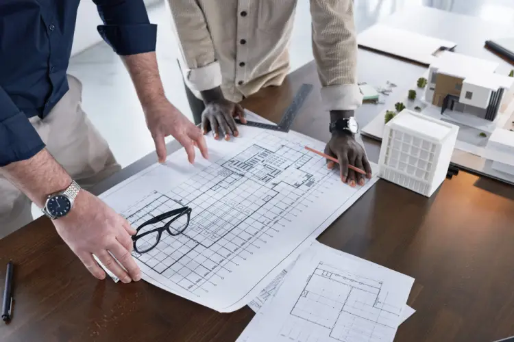 architectural-design-team-working-on-blueprints.jpg