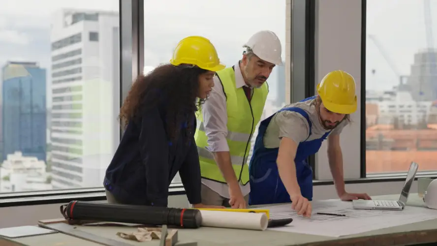 construction-engineers-reviewing-blueprints-office.jpg