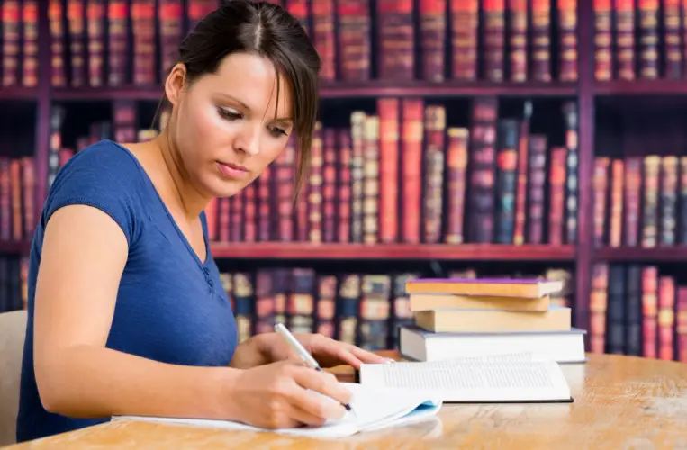 female-student-writing-in-library.jpg