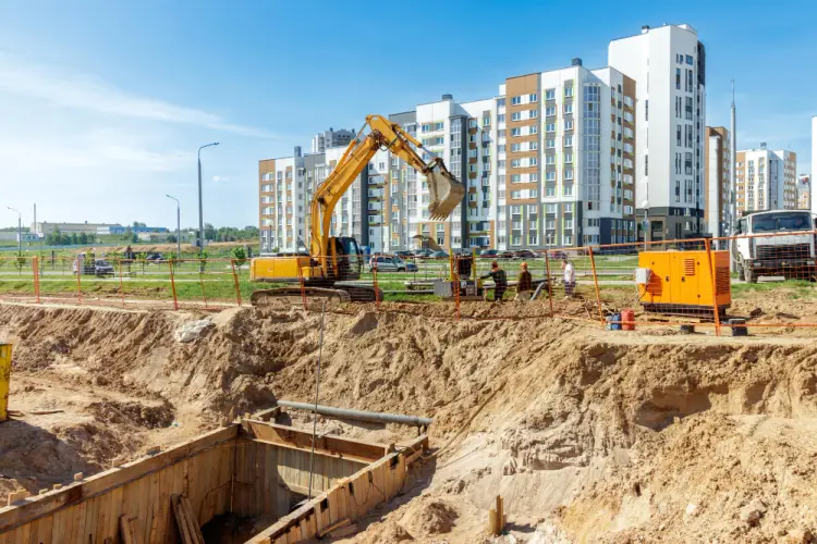 excavator-digging-foundation-urban-housing.jpg