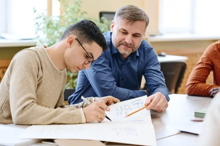 teacher-helping-student-classroom.jpg