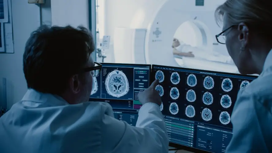 doctors-reviewing-brain-mri-on-monitor.jpg