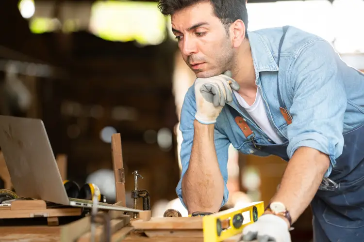 carpenter-working-laptop-his-workshop-woodworking-factory.jpg