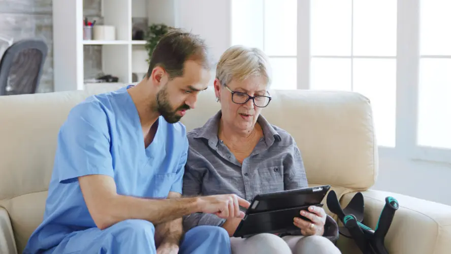 male-nurse-helping-senior-with-tablet-at-home.jpg