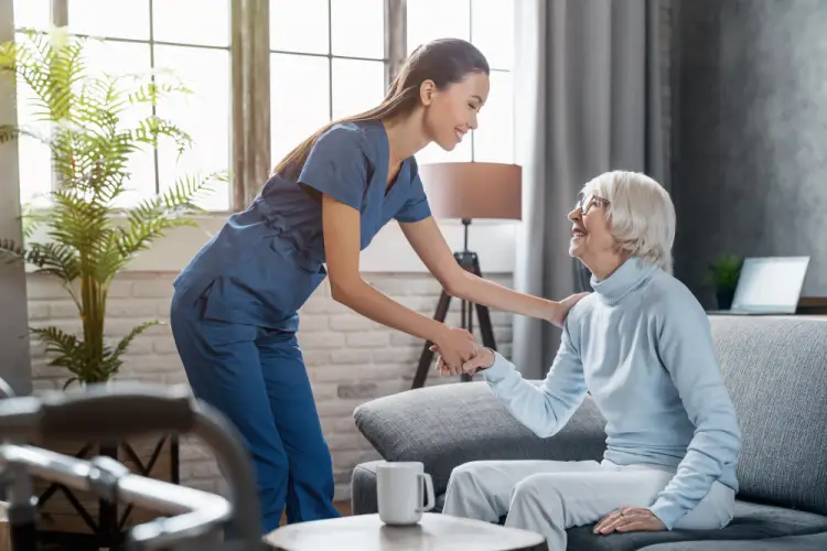 in-home-caregiver-helping-senior-stand.jpg