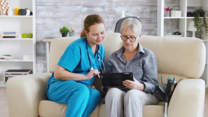 young-nurse-helping-elderly-woman-with-tablet.jpg
