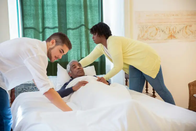 caregivers-assisting-senior-in-hospice-room.jpg