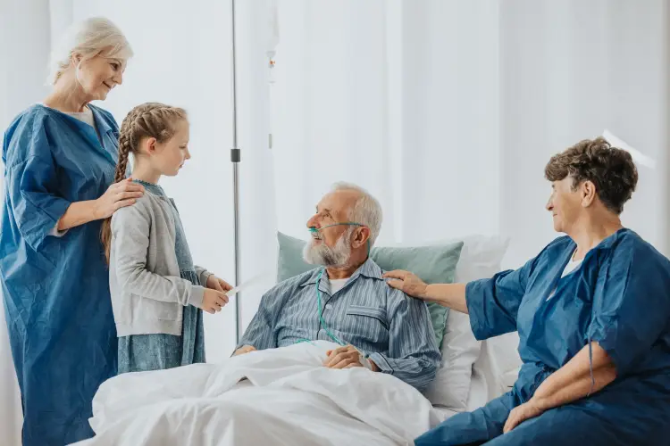 family-around-hospital-bed-visiting-elderly-man.jpg