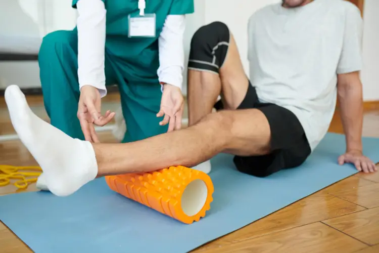 therapist-assisting-leg-rehabilitation-foam-roller.jpg