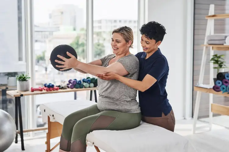 physiotherapist-guiding-patient-core-exercise-medicine-ball.jpg