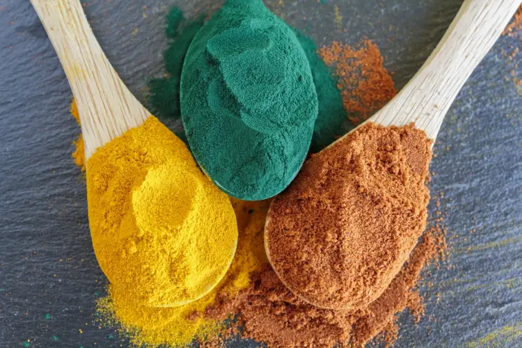 top-view-colorful-healthy-condiments-cayenne-pepper-turmeric-powder-spirulina.jpg