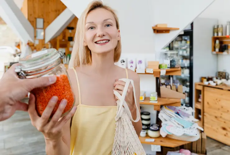 smiling-woman-with-glass-jar-red-lentils-zero-waste-shop.jpg