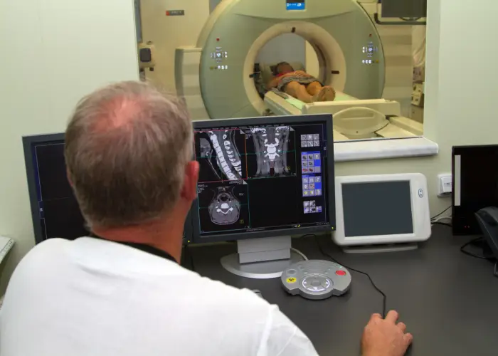 technician-monitoring-ct-scan-from-control-room.jpg