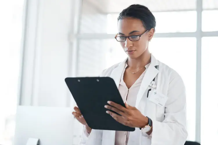 female-doctor-reading-patient-records.jpg