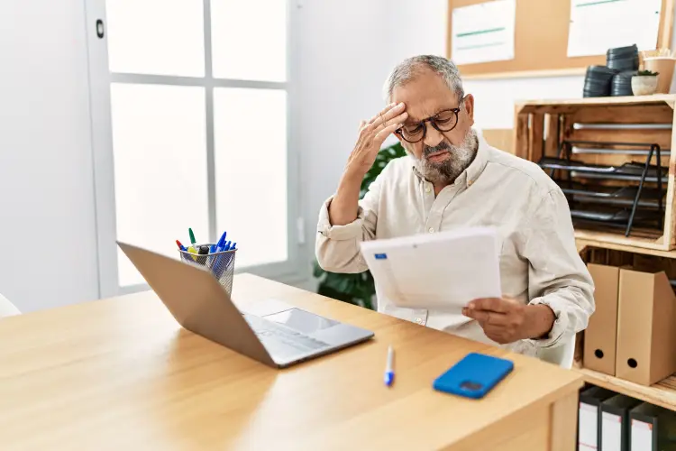senior-greyhaired-man-stressed-working-office.jpg