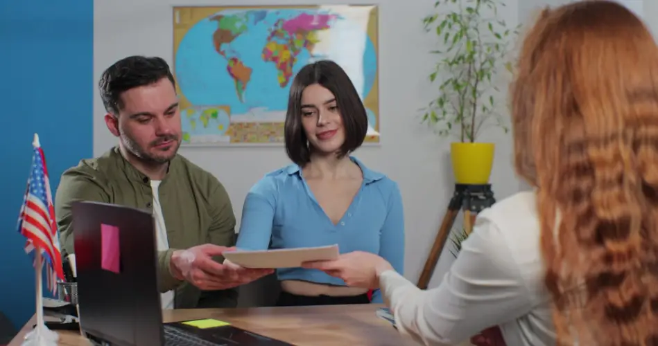 couple-handing-documents-to-government-agent.jpg