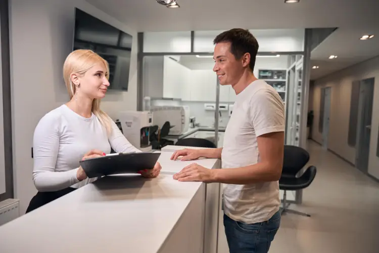 male-customer-speaking-with-front-desk-receptionist.jpg