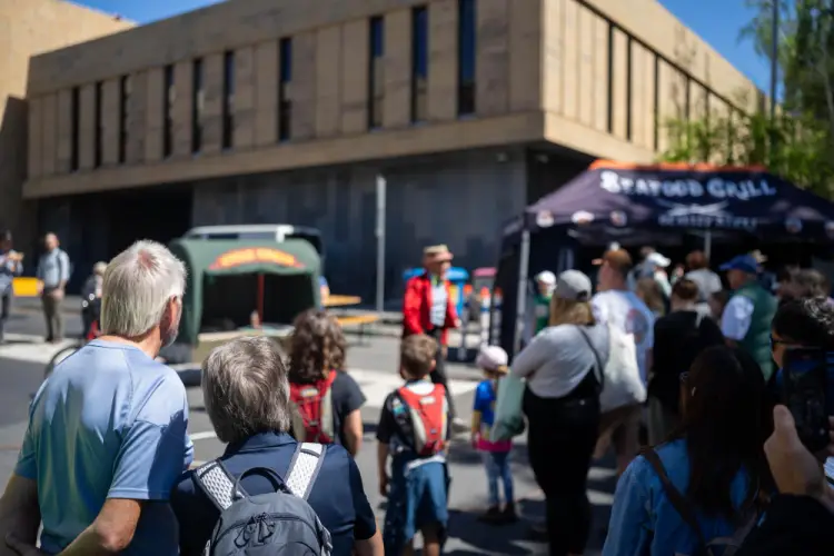 community-gathering-outside-food-tents.jpg