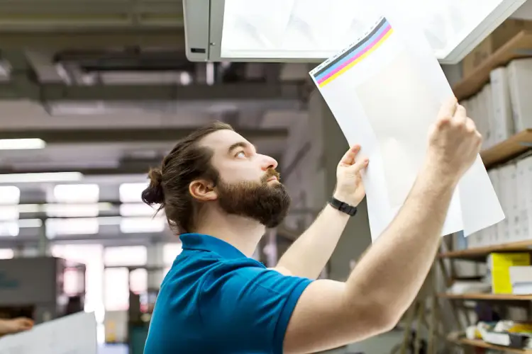 man-checking-color-quality-print-shop.jpg