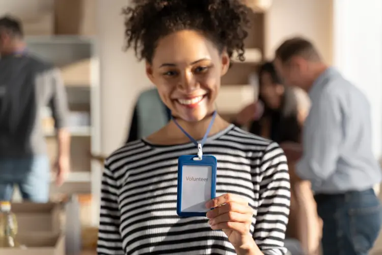smiling-volunteer-showing-name-badge.jpg