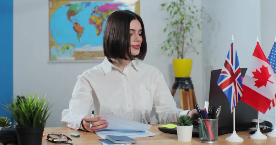 woman-working-international-office-with-canada-uk-flags.jpg