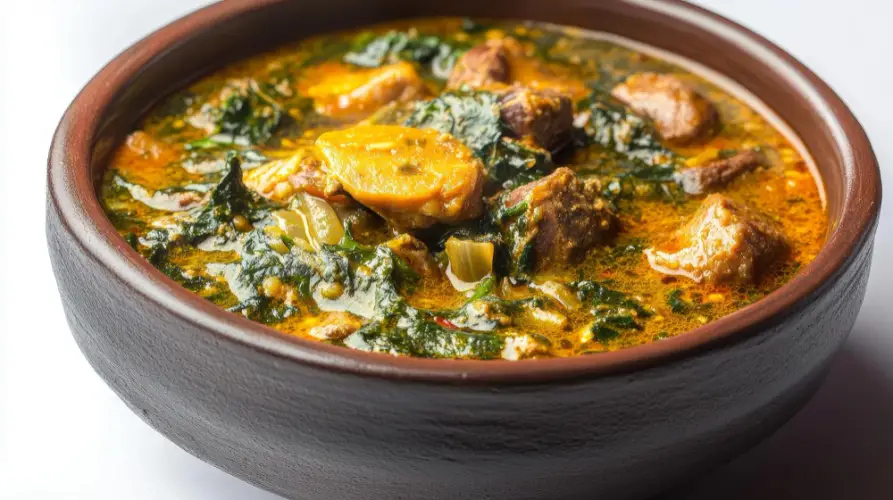 rich-egusi-soup-with-vegetables-and-goat-meat-in-brown-bowl.jpg