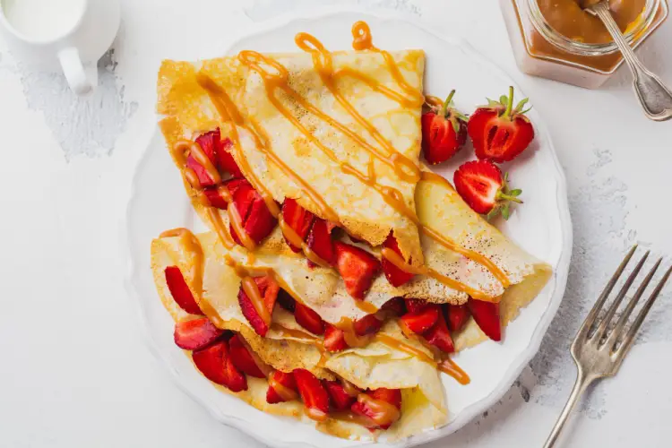 strawberry-crepes-with-caramel-sauce-on-white-plate.jpg