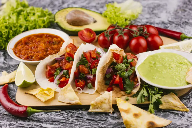 soft-tacos-with-salsa-guacamole-and-tomatoes.jpg