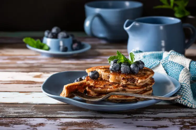 blueberry-pancakes-on-blue-plate-with-mint-garnish.jpg