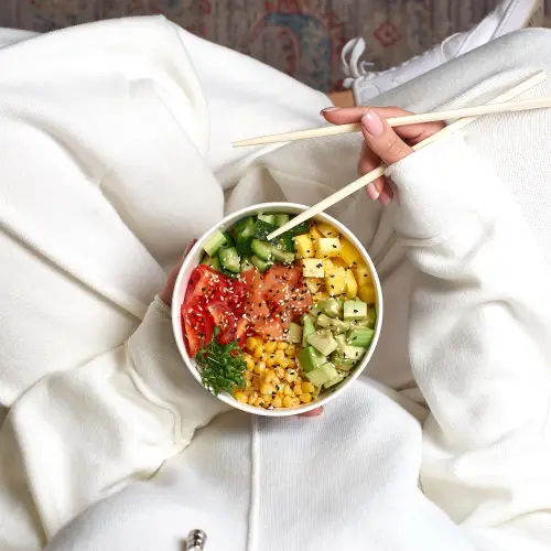 woman-holding-poke-bowl-with-salmon-avocado-and-mango.jpg