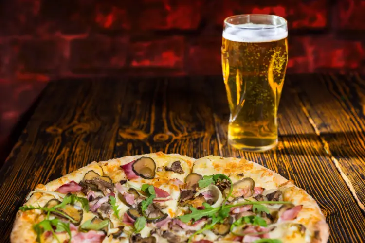 gourmet-pizza-with-beer-on-wooden-table.jpg