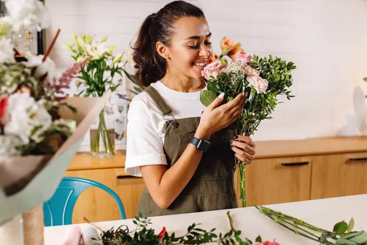 smiling-female-florist-holding-bouquet-shop.jpg